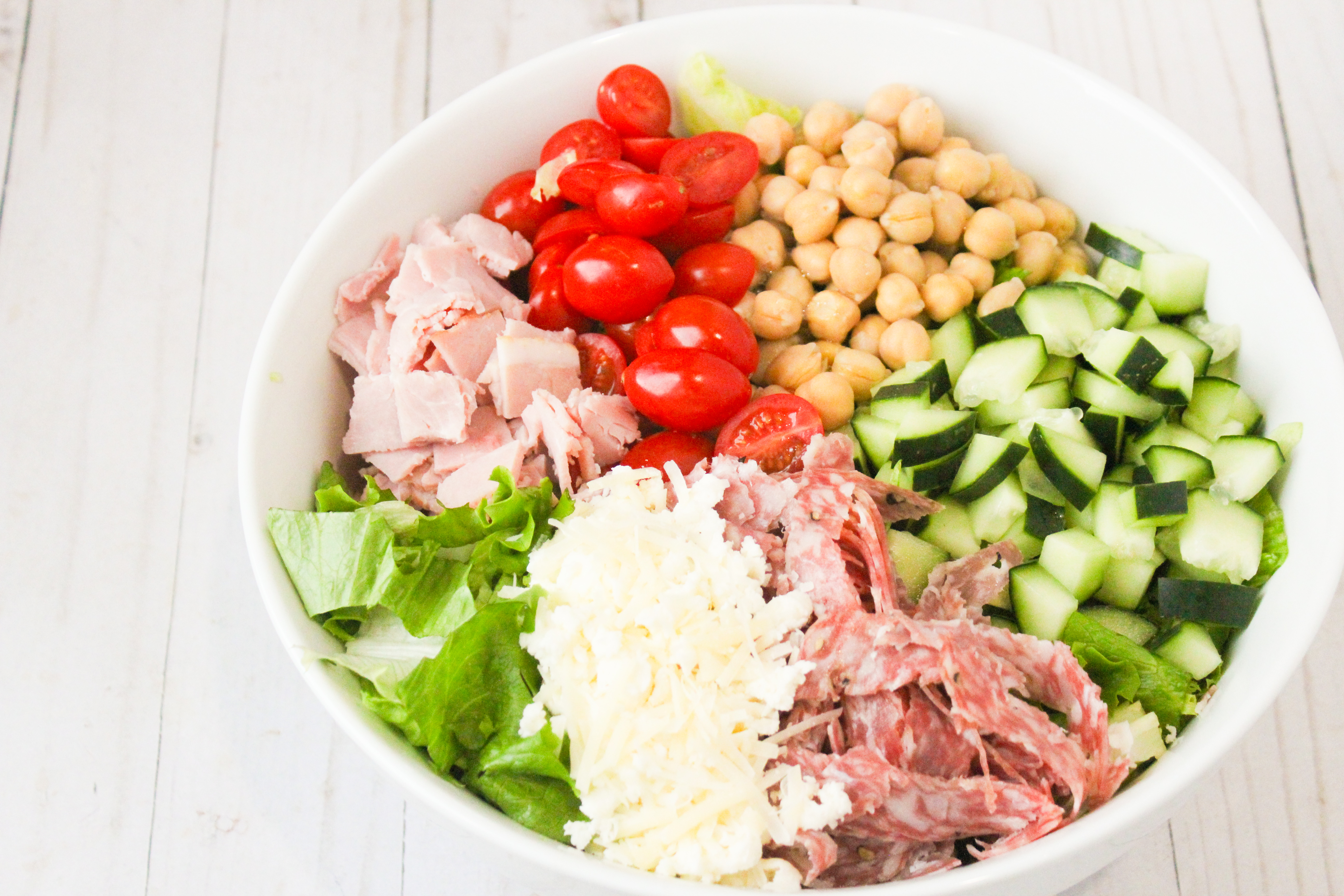  iceberg lettuce in a bowl with an assortment of toppings 